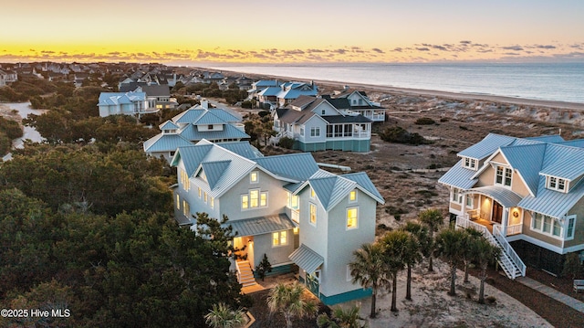 aerial view with a view of the beach, a water view, and a residential view