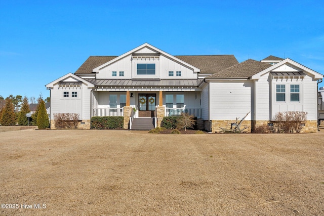 view of front of property with a standing seam roof, covered porch, a shingled roof, board and batten siding, and metal roof