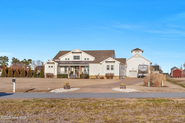 view of front of house featuring covered porch and metal roof