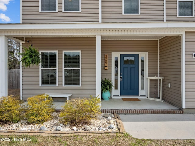 view of exterior entry with covered porch