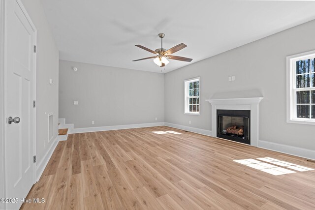 747 Warbler Pl, Vass, NC 28394 - unfurnished living room featuring a fireplace, baseboards, and light wood finished floors