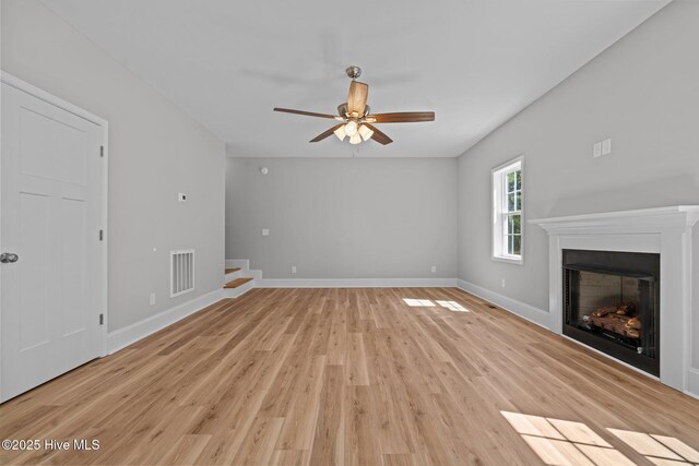 747 Warbler Pl, Vass, NC 28394 - unfurnished living room featuring light wood-type flooring, visible vents, baseboards, and a fireplace