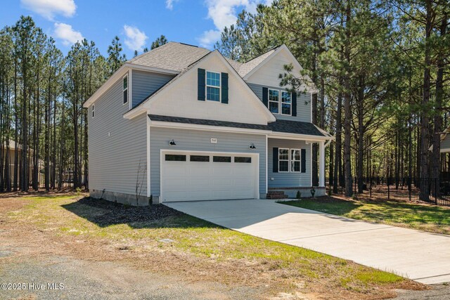 747 Warbler Pl, Vass, NC 28394 - traditional home with a garage, driveway, and a shingled roof