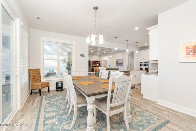 111 E Magens Ct, Cedar Point, NC 28584 - dining room with light wood-type flooring, a chandelier, and recessed lighting