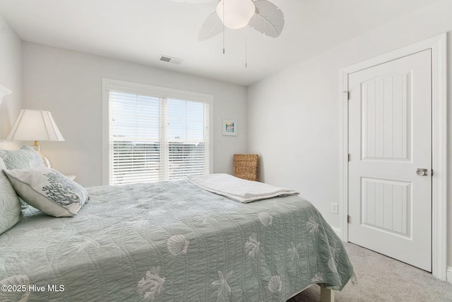 bedroom featuring visible vents, carpet floors, and ceiling fan