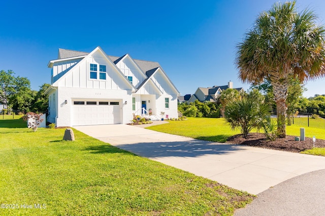111 E Magens Ct, Cedar Point, NC 28584 - modern inspired farmhouse featuring board and batten siding, driveway, a front yard, and a garage
