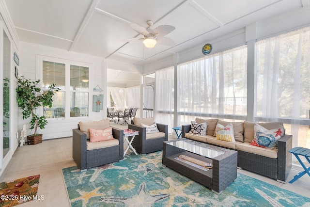 sunroom / solarium featuring plenty of natural light and a ceiling fan