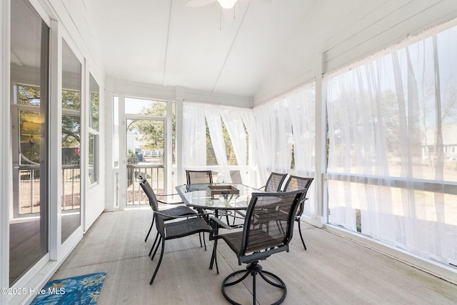 sunroom / solarium with a ceiling fan and lofted ceiling