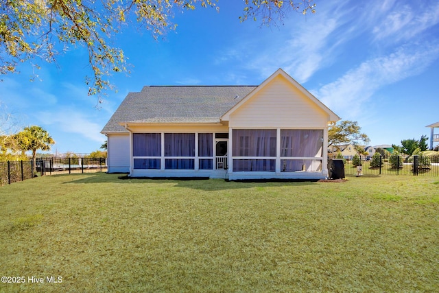 111 E Magens Ct, Cedar Point, NC 28584 - back of property with a sunroom, roof with shingles, and a fenced backyard