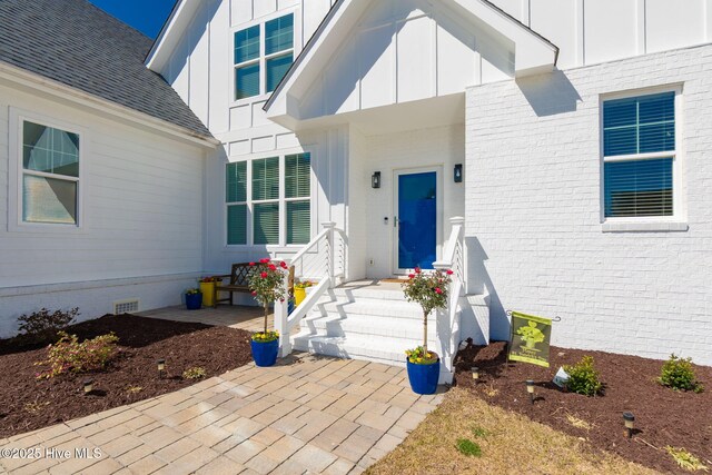 111 E Magens Ct, Cedar Point, NC 28584 - entrance to property featuring board and batten siding, crawl space, and roof with shingles