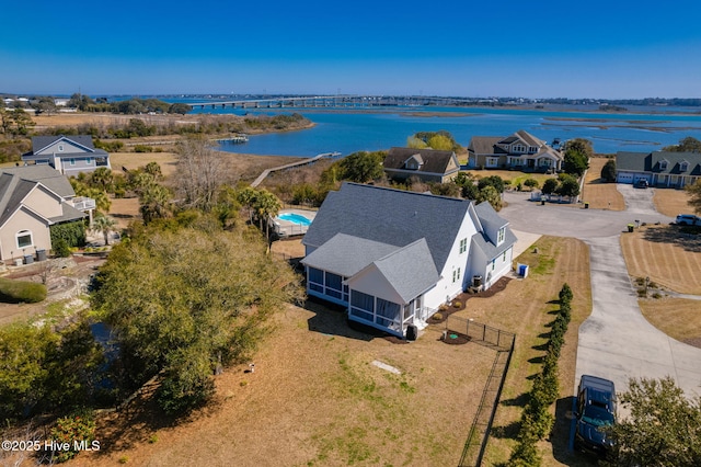 birds eye view of property with a residential view and a water view