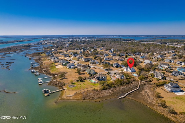 drone / aerial view with a water view and a residential view