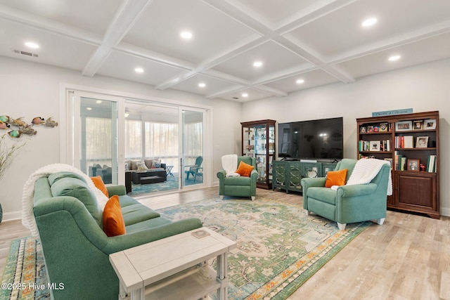 living area with beam ceiling, visible vents, coffered ceiling, and light wood-type flooring