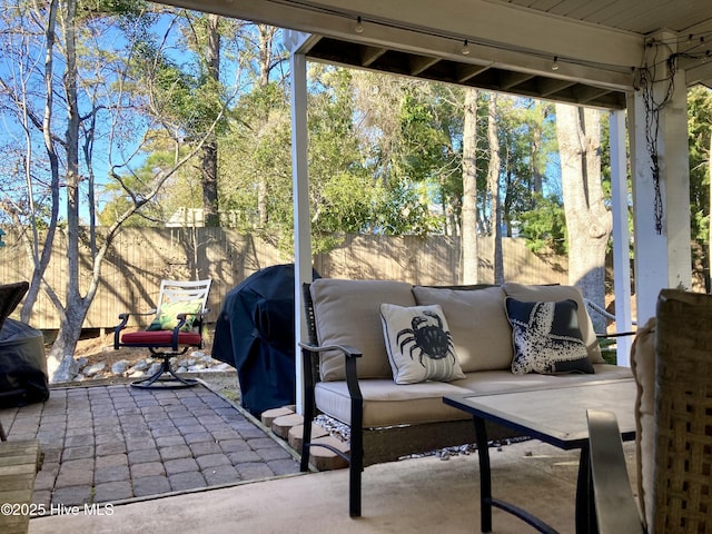 view of patio / terrace featuring an outdoor hangout area and fence