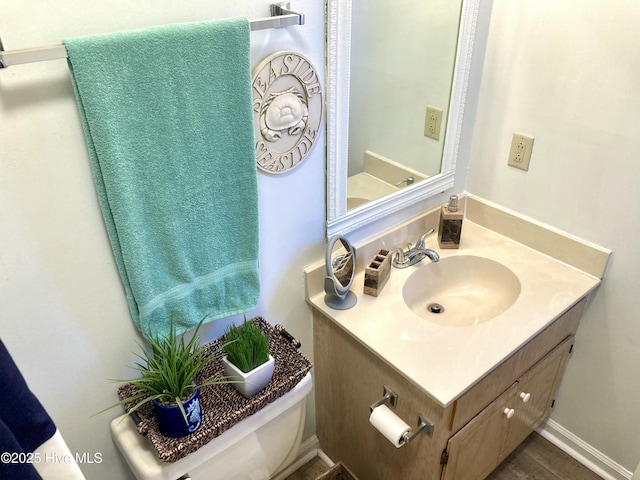 bathroom with toilet and vanity