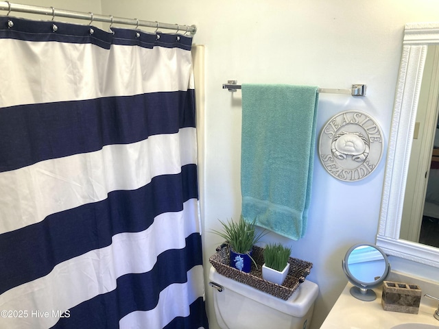 bathroom with a shower with curtain and toilet