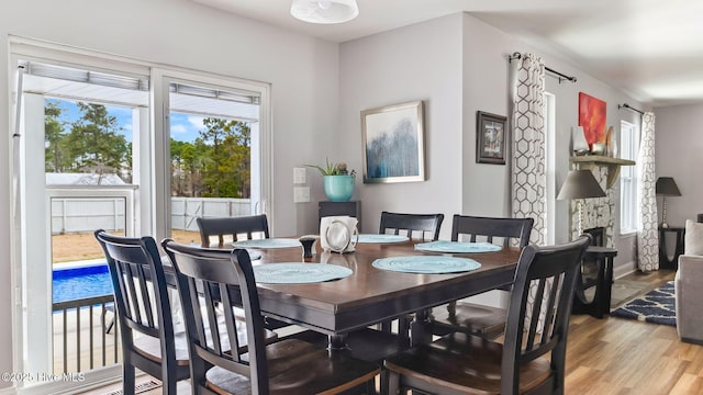 dining area featuring baseboards and light wood finished floors