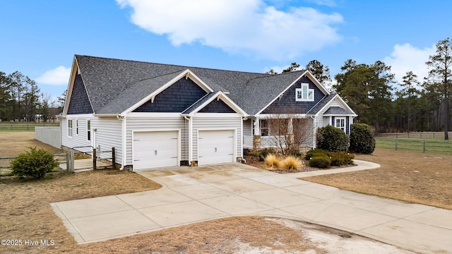 view of front of house featuring a garage, roof with shingles, driveway, and fence