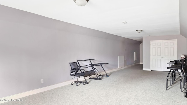 living area featuring lofted ceiling, baseboards, and carpet floors