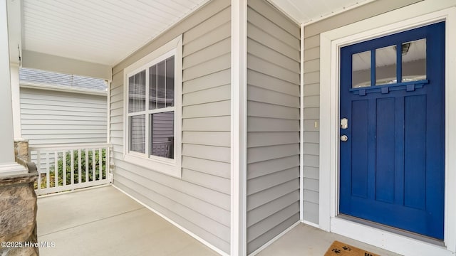 doorway to property featuring covered porch