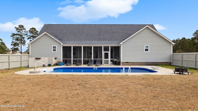 view of pool featuring a lawn, a fenced backyard, a sunroom, and a fire pit