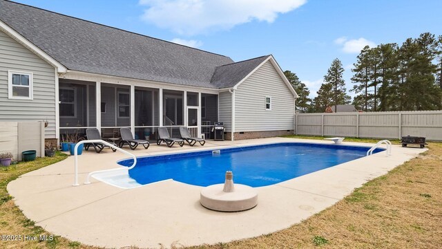 view of swimming pool featuring a patio area, a fenced in pool, fence, and a sunroom