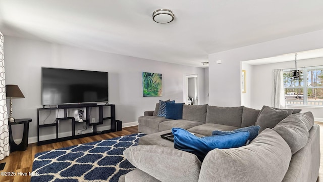 living area featuring baseboards and wood finished floors