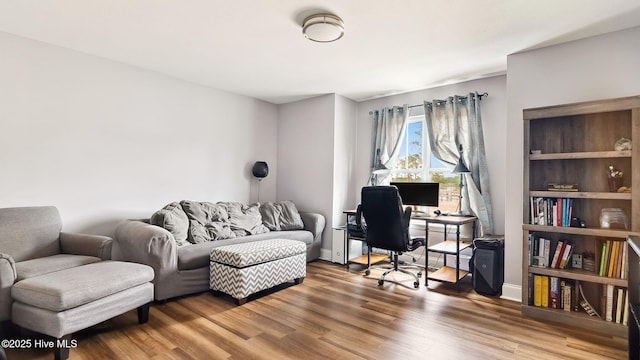 home office featuring baseboards and wood finished floors