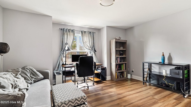 office with baseboards and wood finished floors