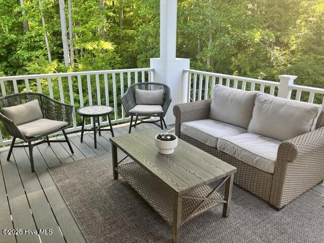 wooden terrace featuring an outdoor hangout area