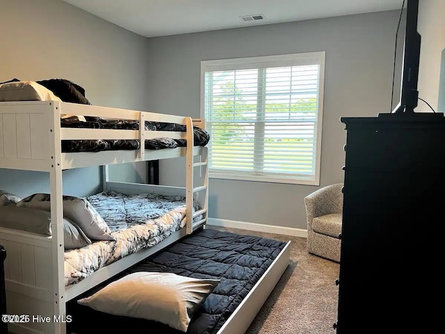 carpeted bedroom featuring visible vents and baseboards