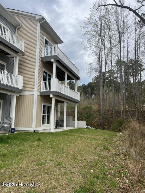 back of property with a patio and a yard