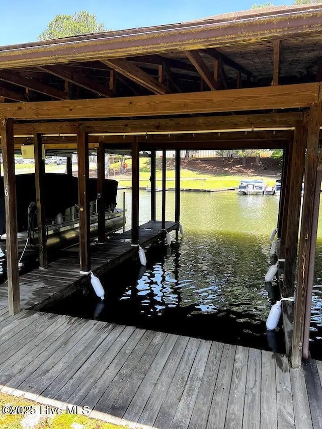 view of dock featuring a water view and boat lift