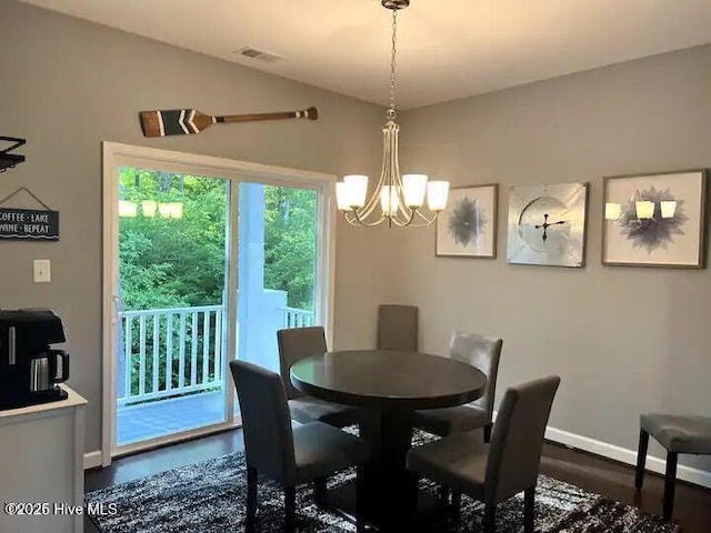 dining space featuring lofted ceiling, a notable chandelier, baseboards, and visible vents