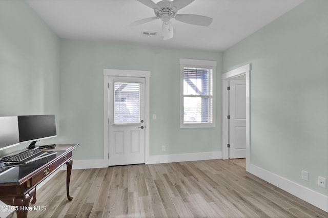 interior space featuring ceiling fan, baseboards, visible vents, and light wood-type flooring