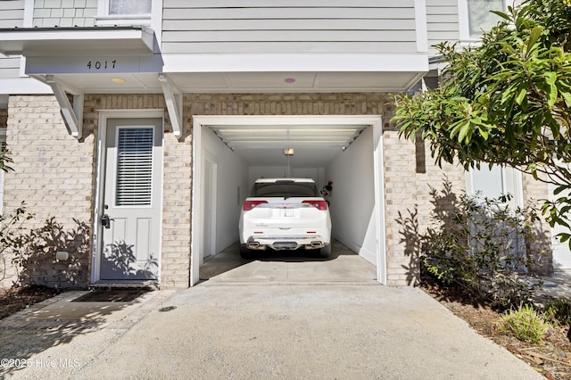 garage featuring concrete driveway