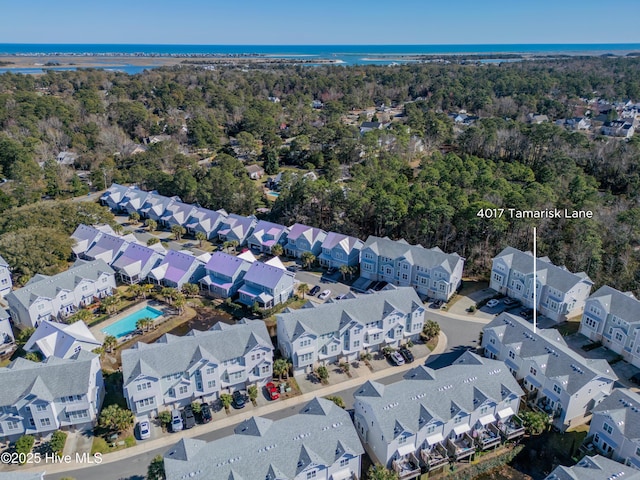 drone / aerial view featuring a residential view and a water view