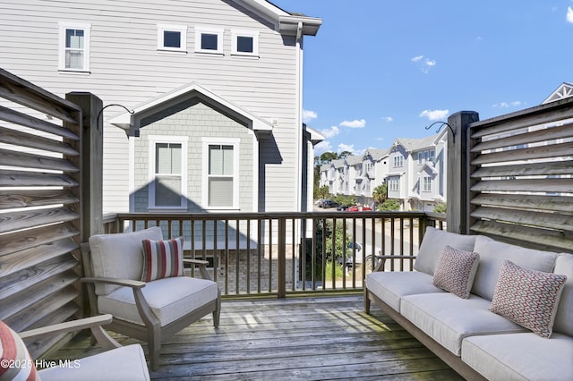 wooden terrace featuring an outdoor living space and a residential view