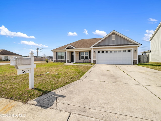 view of front of home featuring driveway, a front lawn, stone siding, board and batten siding, and a garage