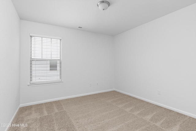 empty room with carpet flooring and baseboards