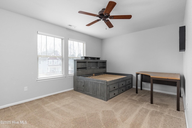 carpeted office space featuring visible vents, baseboards, and ceiling fan