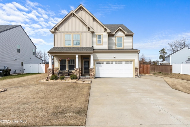 craftsman inspired home with stone siding, fence, board and batten siding, covered porch, and concrete driveway