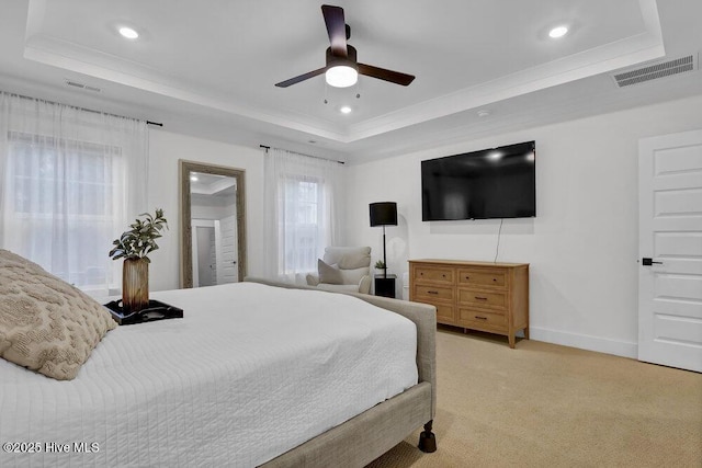 bedroom featuring visible vents, baseboards, light colored carpet, recessed lighting, and a raised ceiling