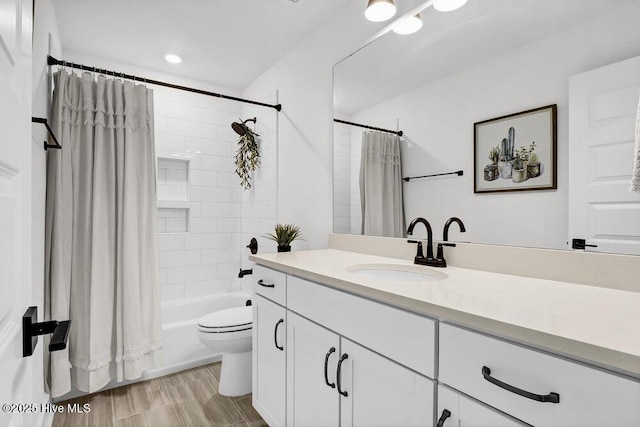 full bathroom with toilet, vanity, and shower / tub combo