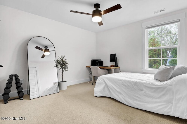 carpeted bedroom featuring visible vents, baseboards, and a ceiling fan