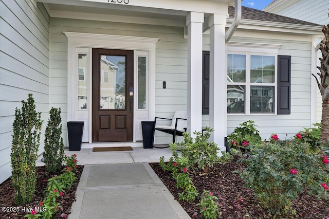 view of exterior entry with a porch