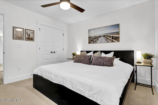 bedroom featuring a closet, baseboards, carpet, and a ceiling fan