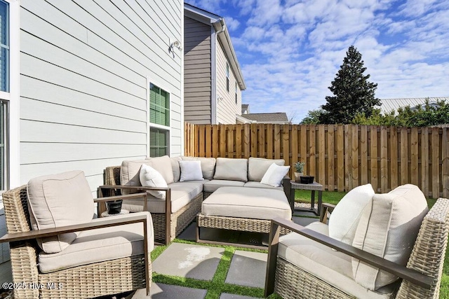 view of patio / terrace with outdoor lounge area and fence