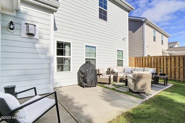 back of house with a patio area, an outdoor living space, and fence