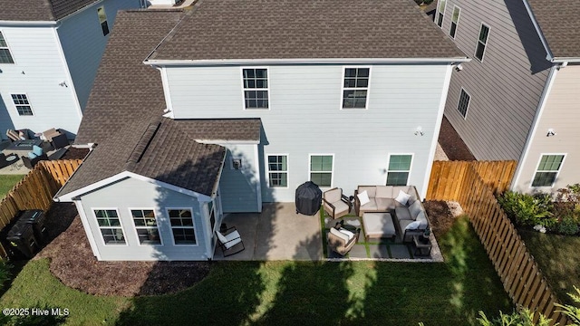 rear view of property with a patio area, a fenced backyard, and roof with shingles